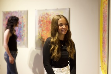 Two women viewing artwork hanging in a gallery