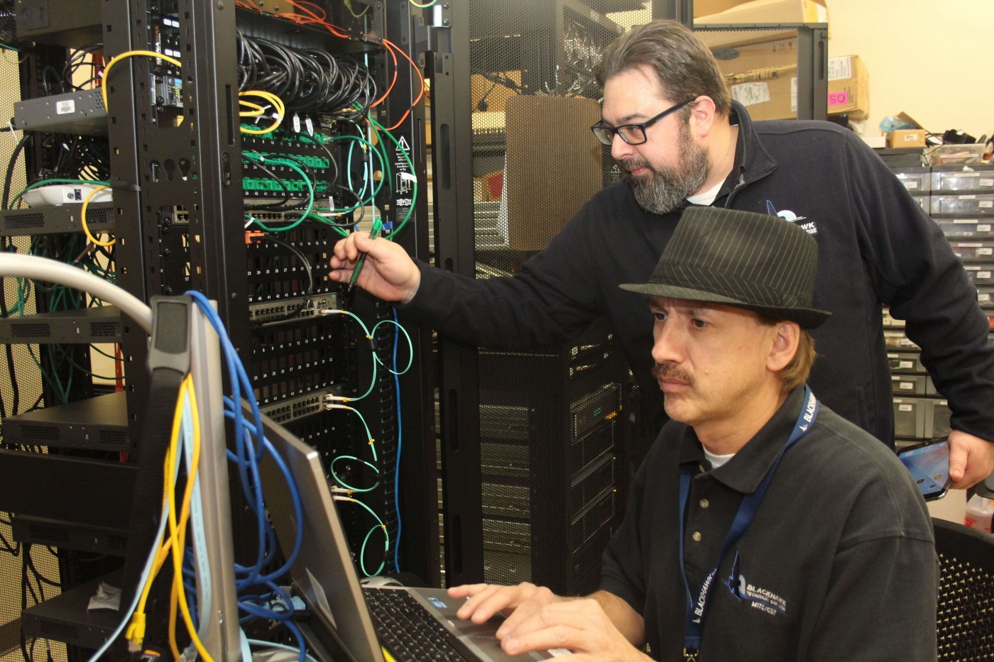 Two people working on servers