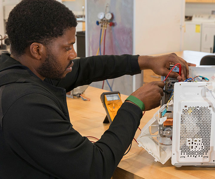 Student repairing computer