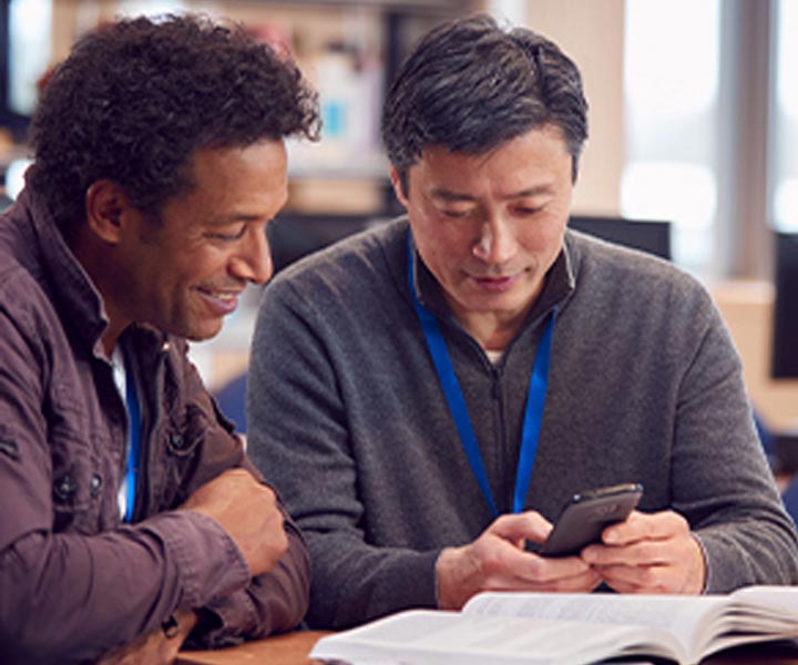Two men looking at a phone