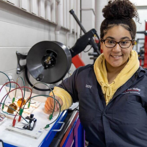 Automotive student working with electronic wires