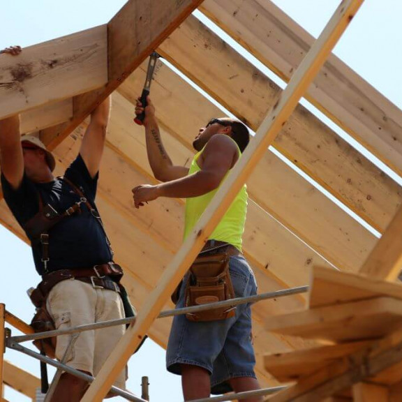 Two construction students framing a roof