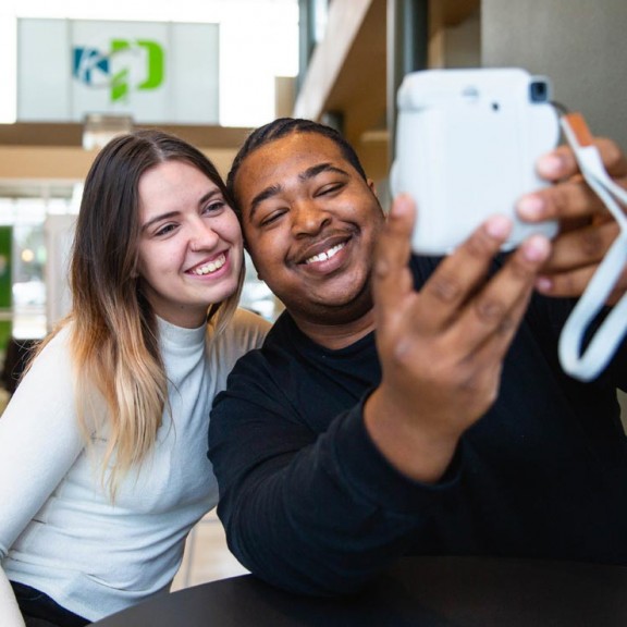 Students taking a selfie in campus common area