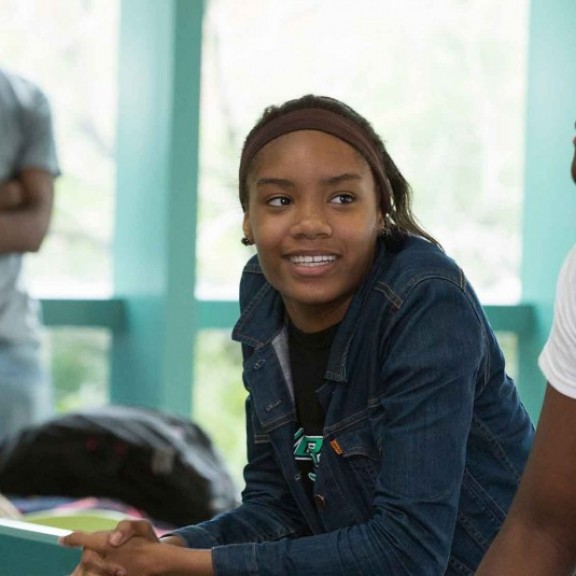 Students handing out in student life office smiling