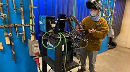 Welding student with machinery