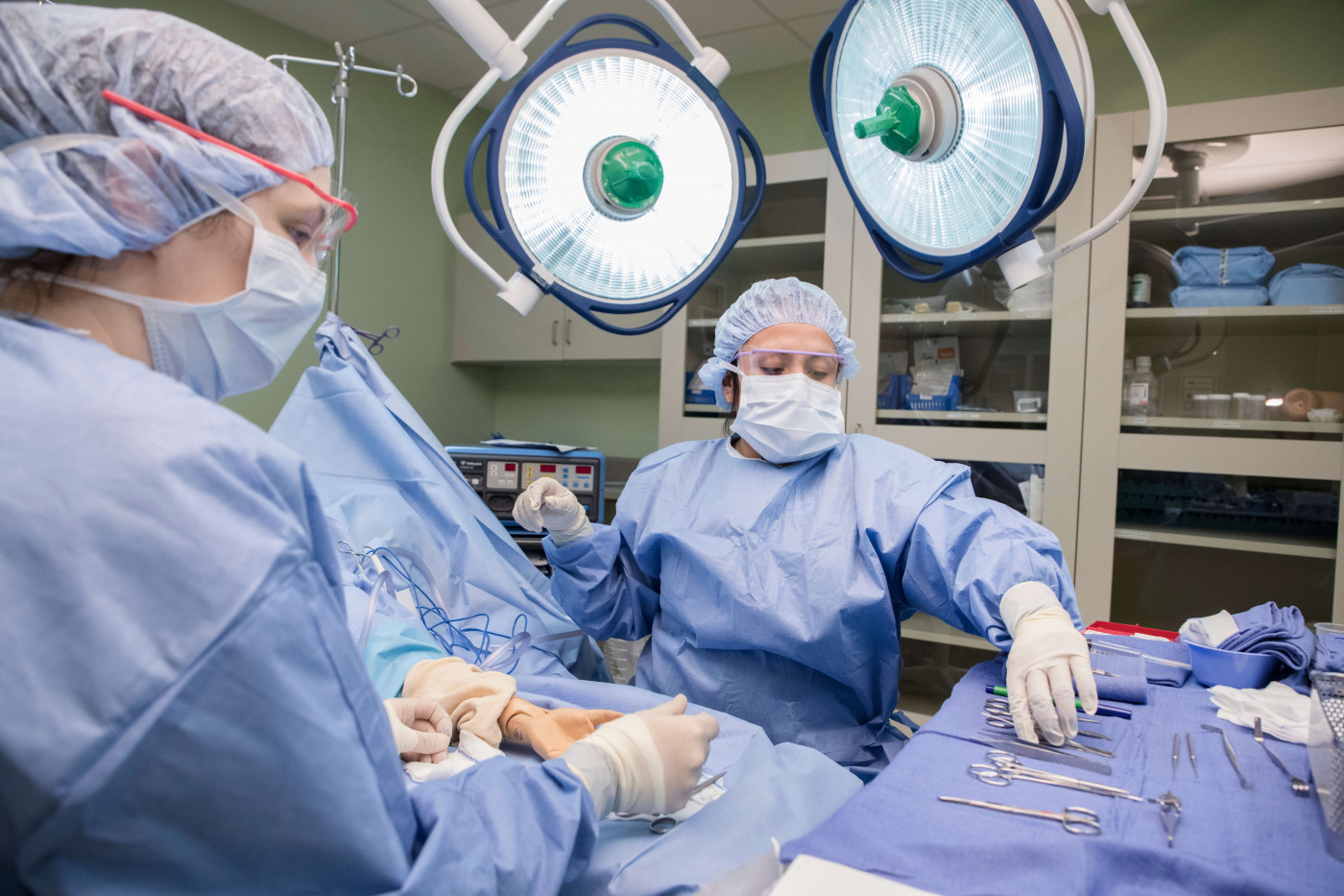 Students working in an operating room during surgery